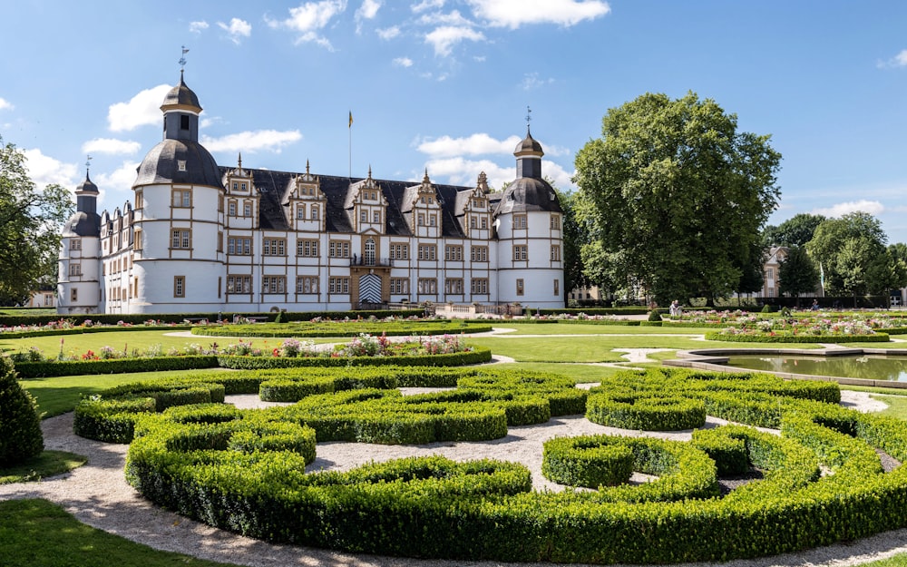 a large building with a garden in front of it