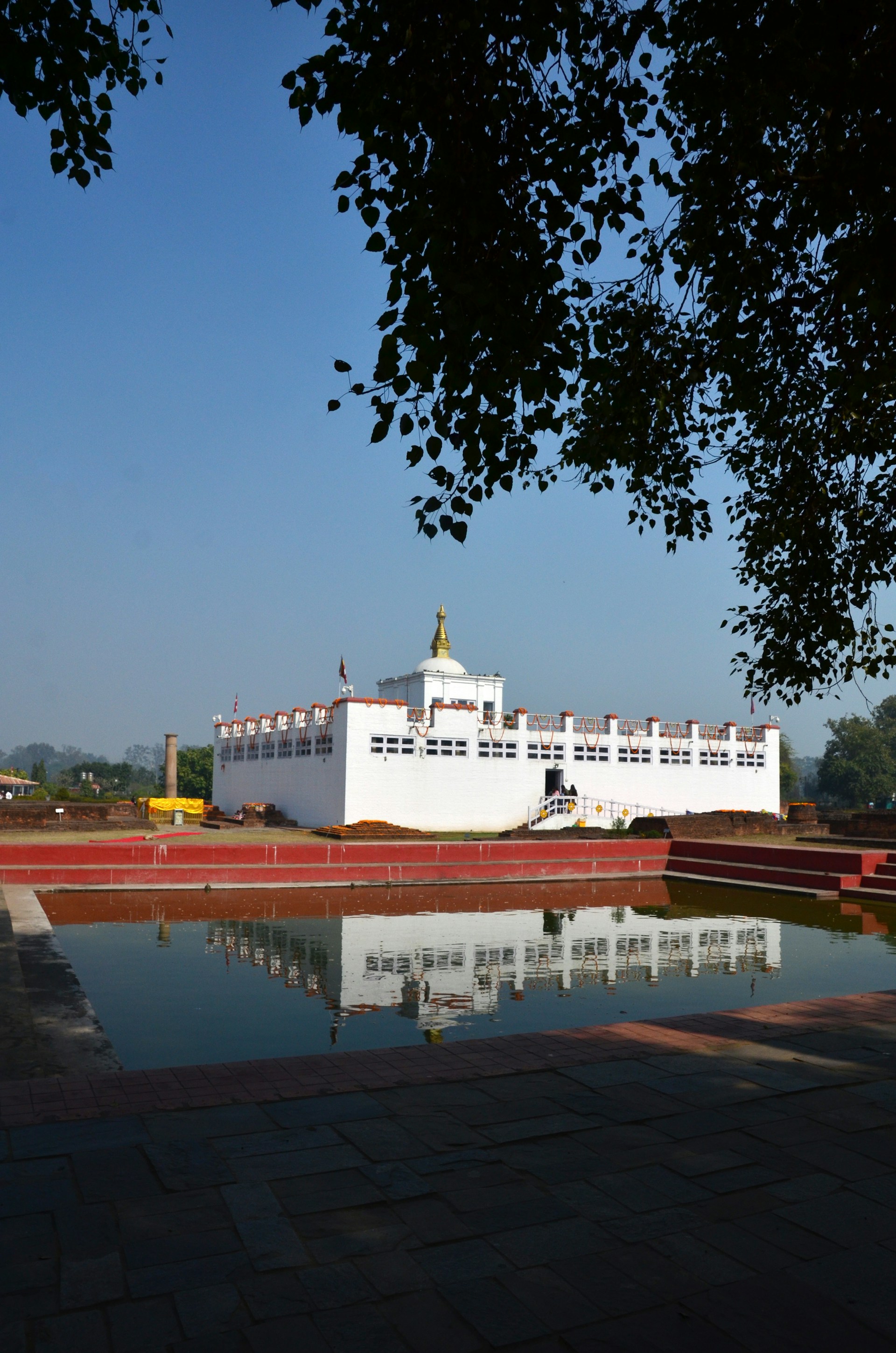 a large white building sitting next to a body of water