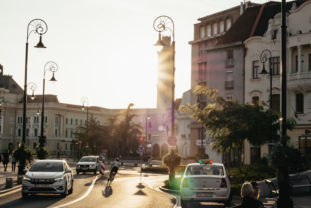 a city street with cars and people on bicycles