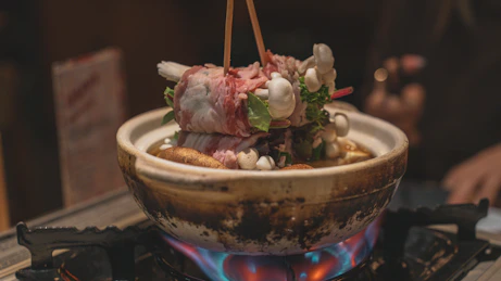 a bowl of food sitting on top of a stove