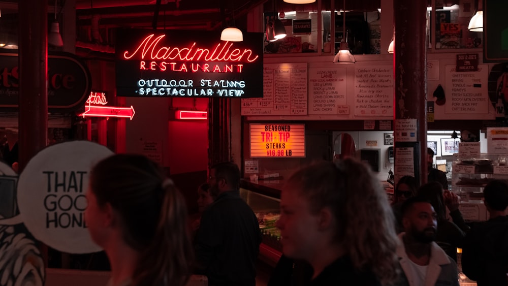 a group of people standing around a restaurant