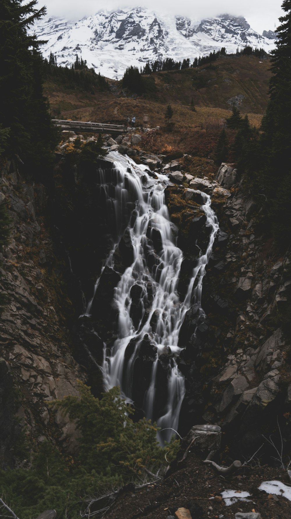 a waterfall with a mountain in the background