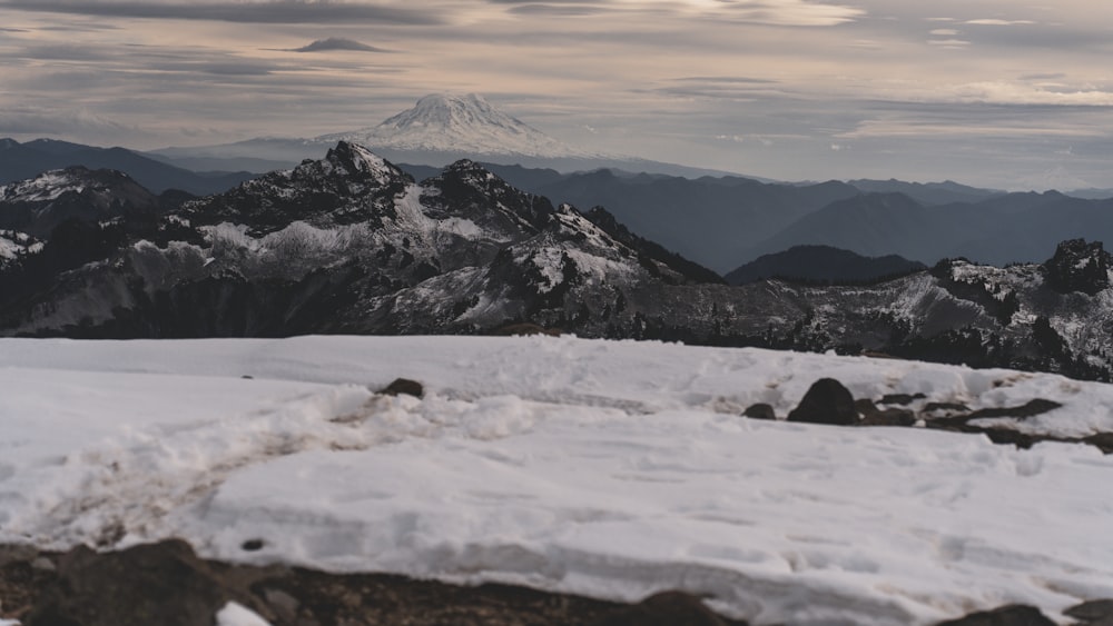 a view of a mountain range covered in snow