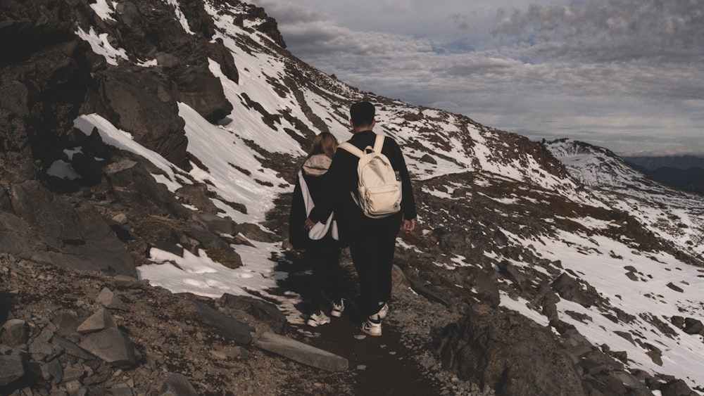 a couple of people that are standing on a mountain