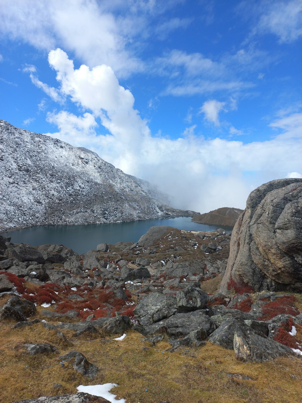 a mountain with a body of water in the middle of it