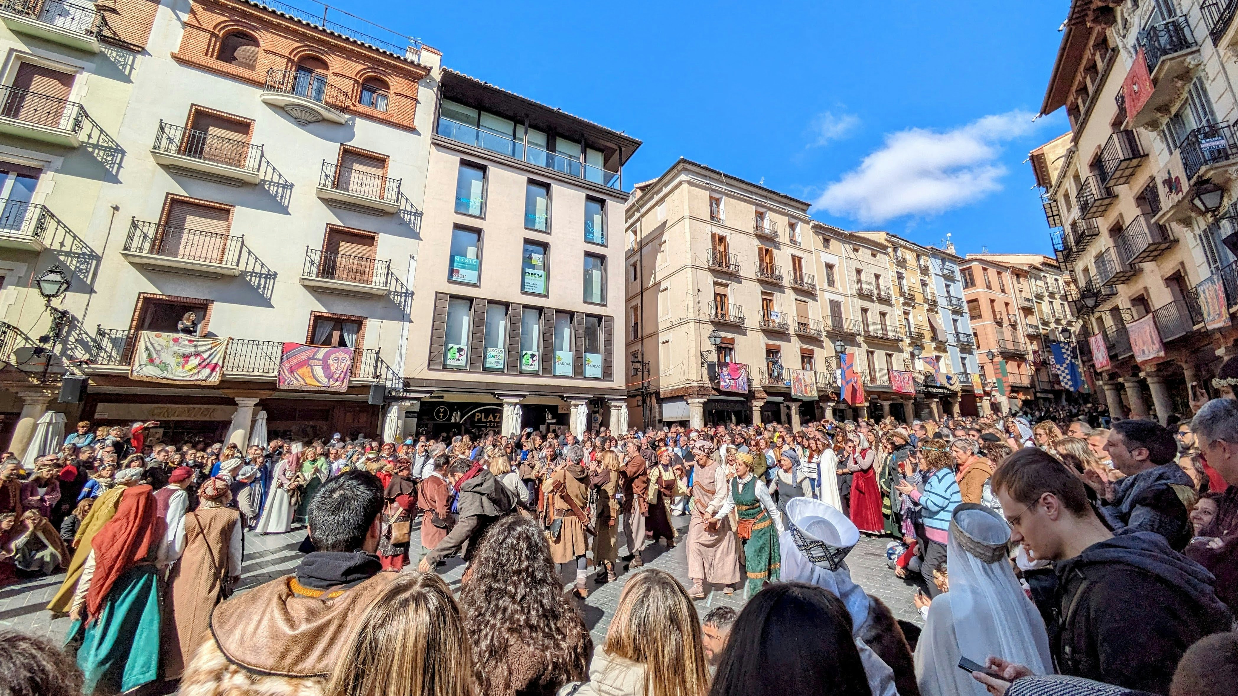 a crowd of people standing in front of tall buildings