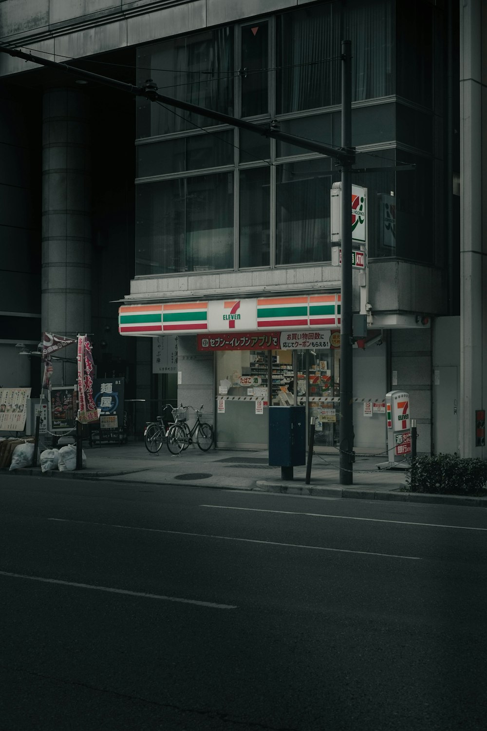 an empty street in front of a tall building