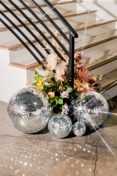 a bunch of disco balls sitting on the ground