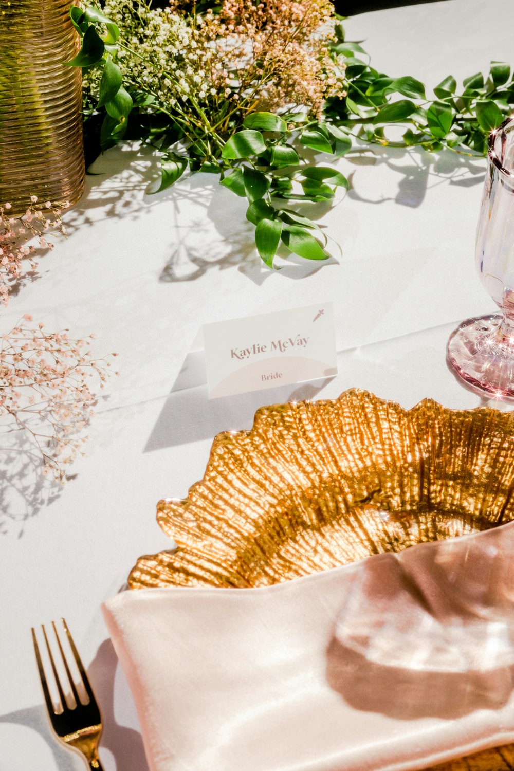 a table set with a place setting and flowers