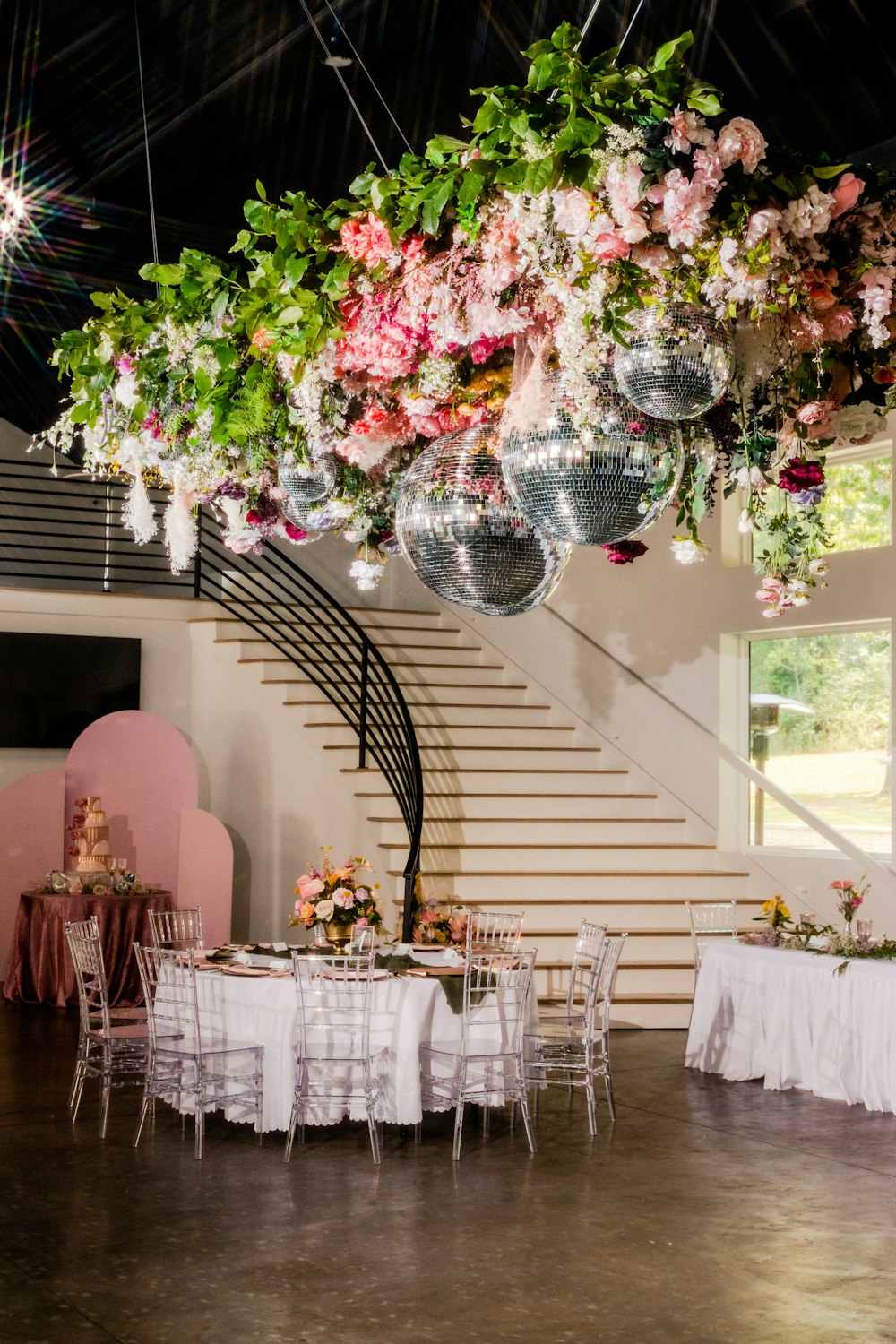 a room with a bunch of flowers hanging from the ceiling