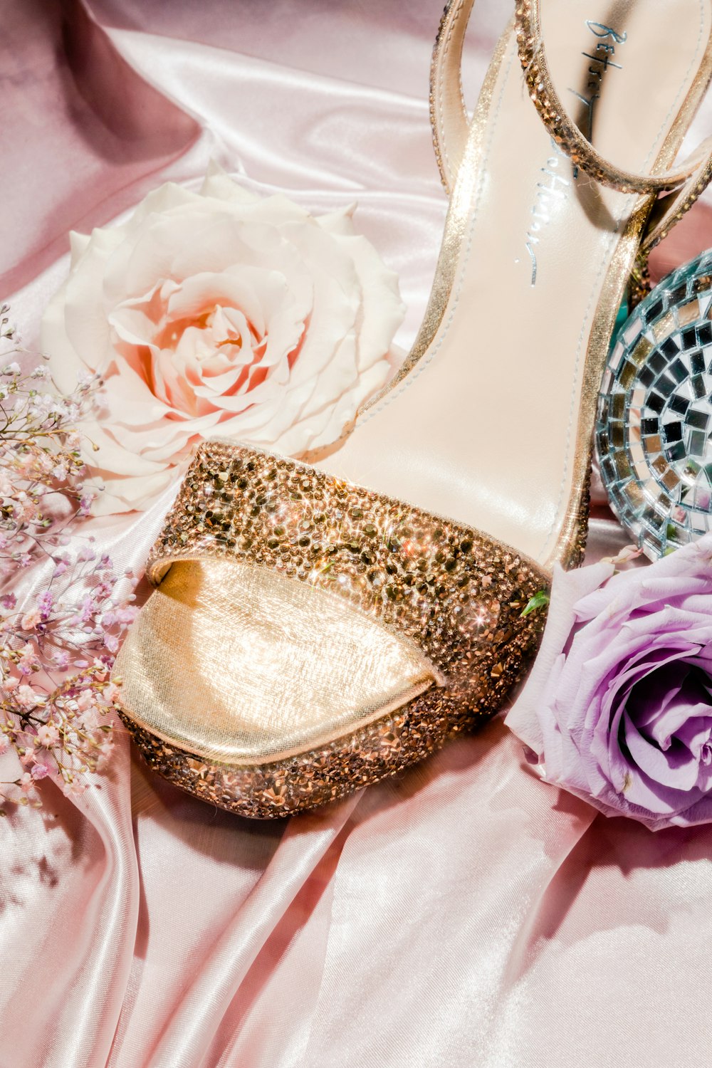 a close up of a pair of shoes and flowers
