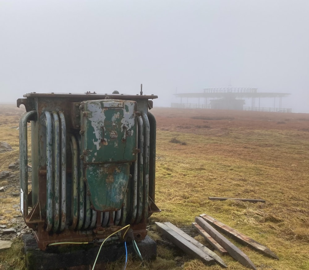 an old, rusted out, metal container sitting in a field