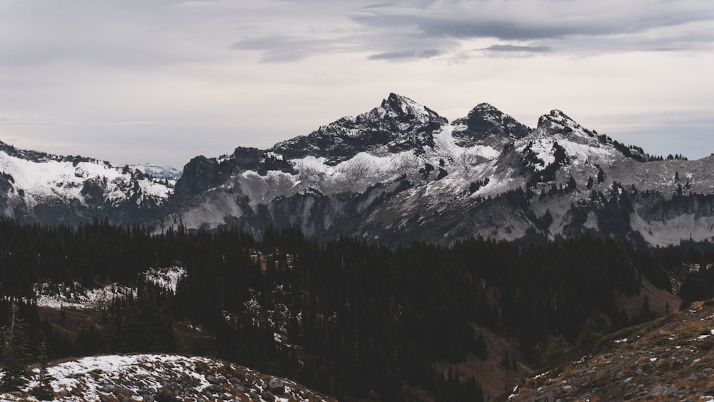 a mountain range with snow covered mountains in the background