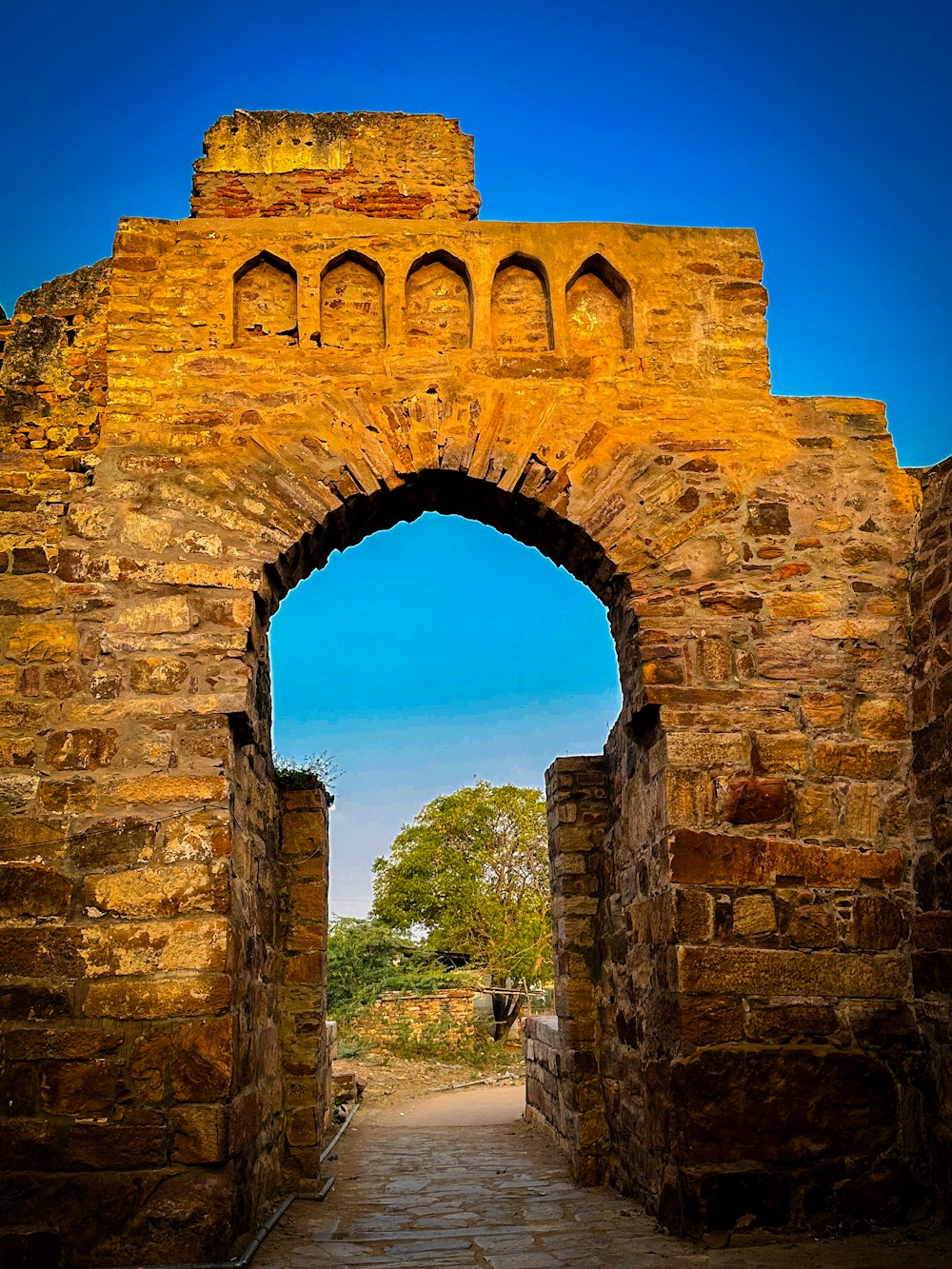a stone archway with a blue sky in the background