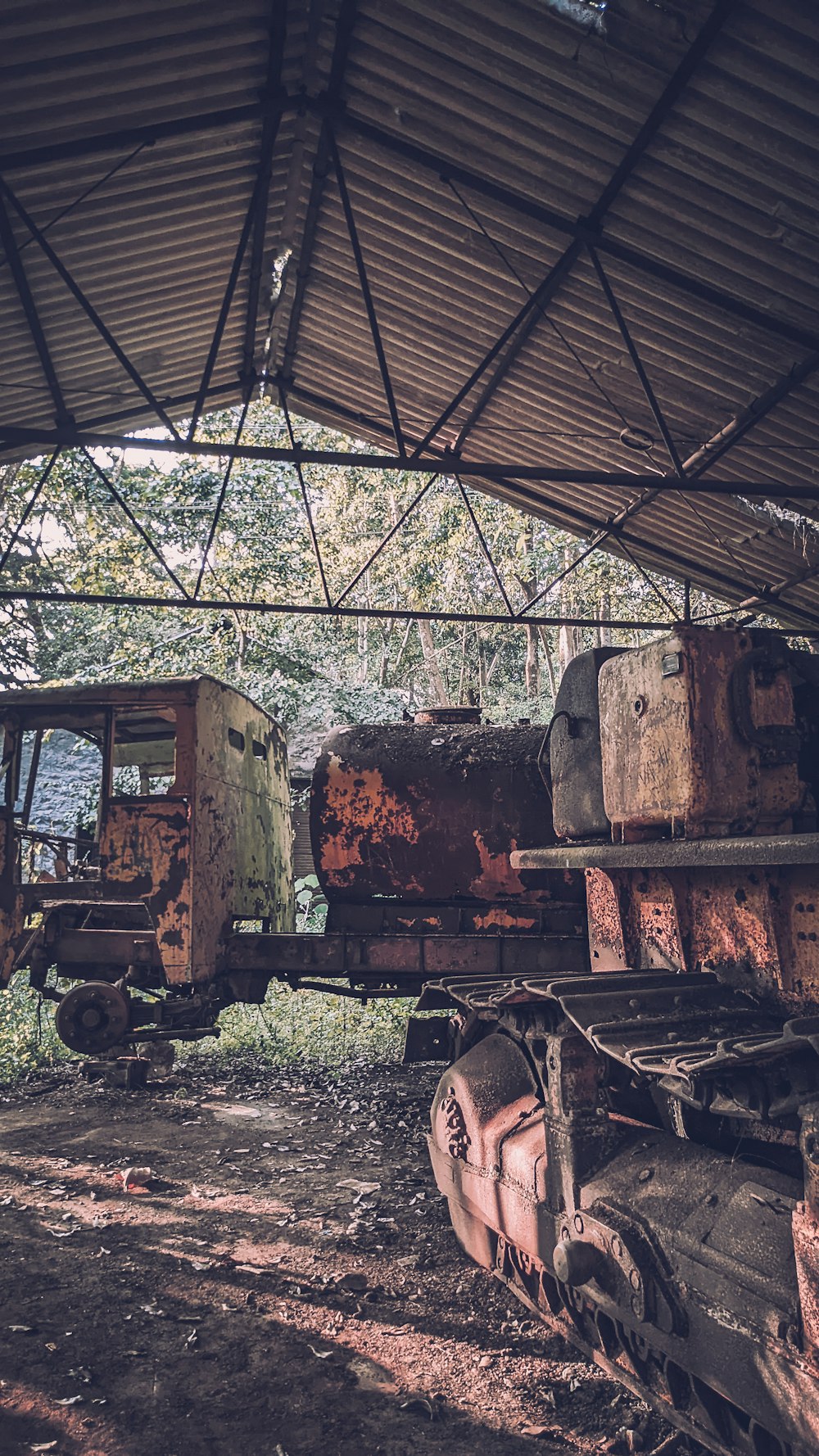 an old train car sitting under a roof