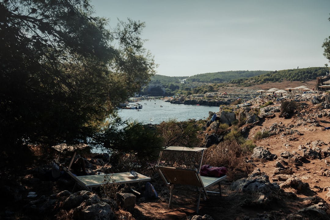 a couple of chairs sitting on top of a rocky hillside, Puglia landscape