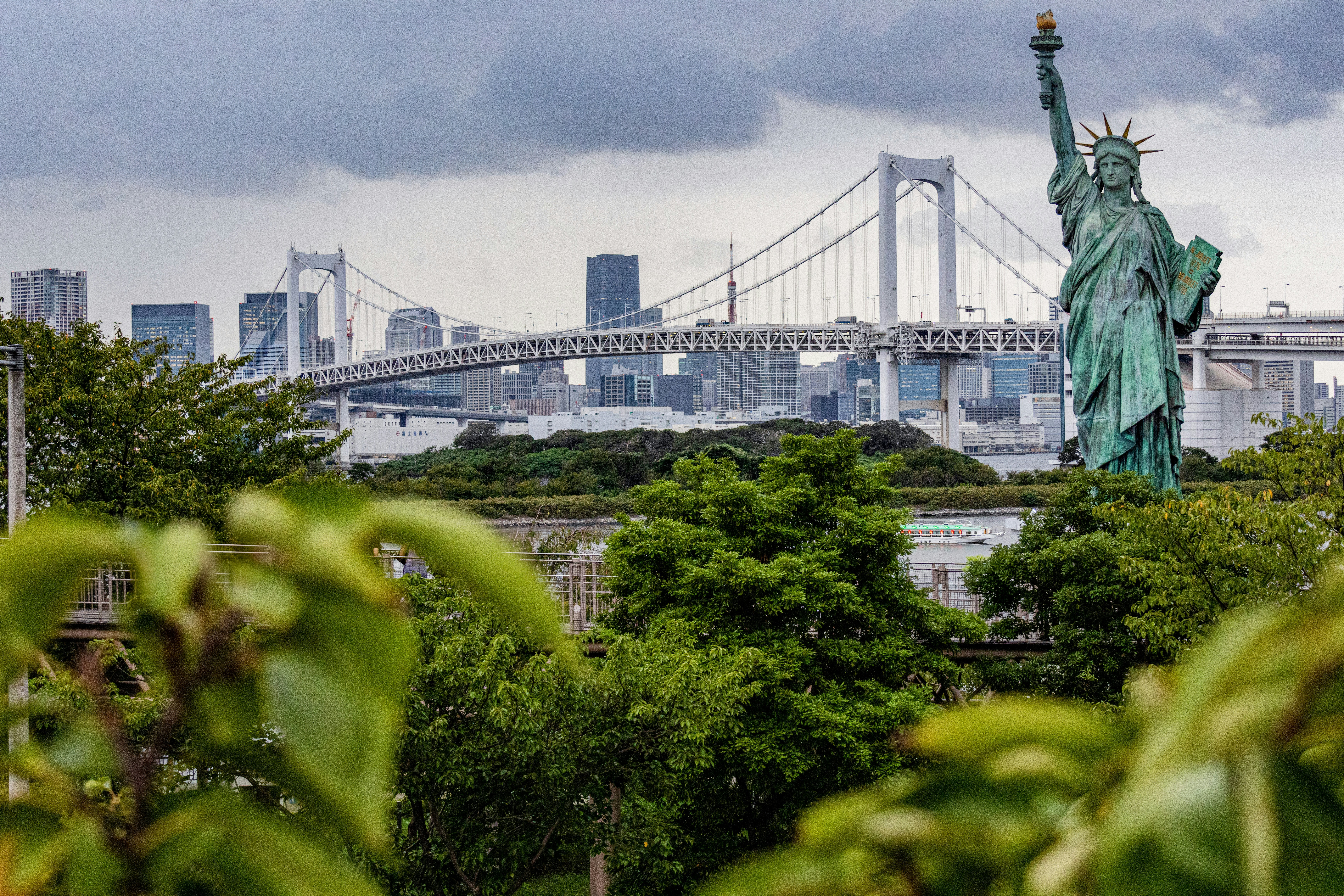 the statue of liberty stands in front of the city skyline, Odaiba Statue of Liberty.