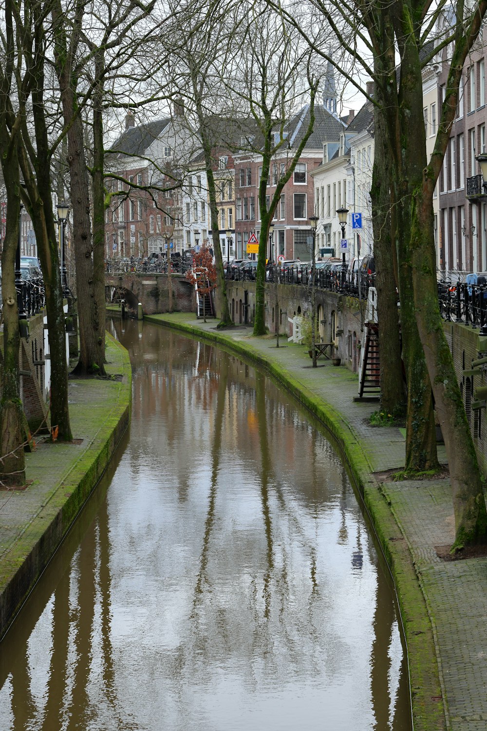 a river running through a city next to tall buildings