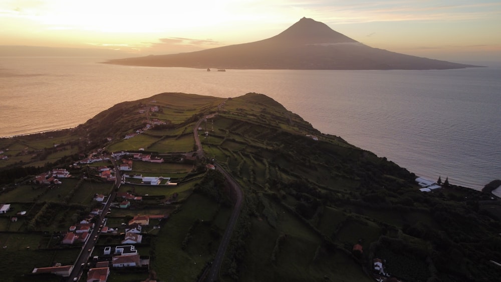 an aerial view of a small town and a mountain