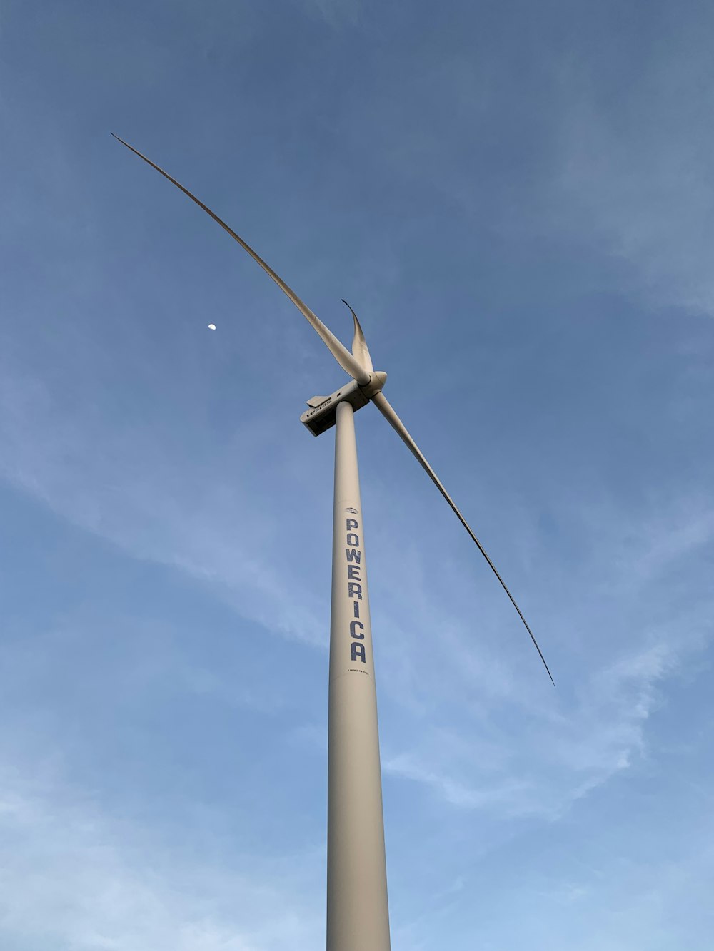 a wind turbine is shown against a blue sky