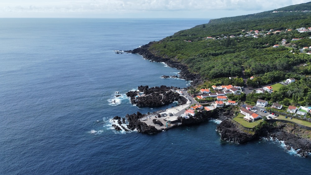 an aerial view of a small village on the edge of the ocean