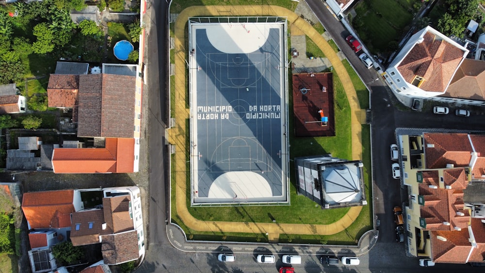 an aerial view of a basketball court in a neighborhood
