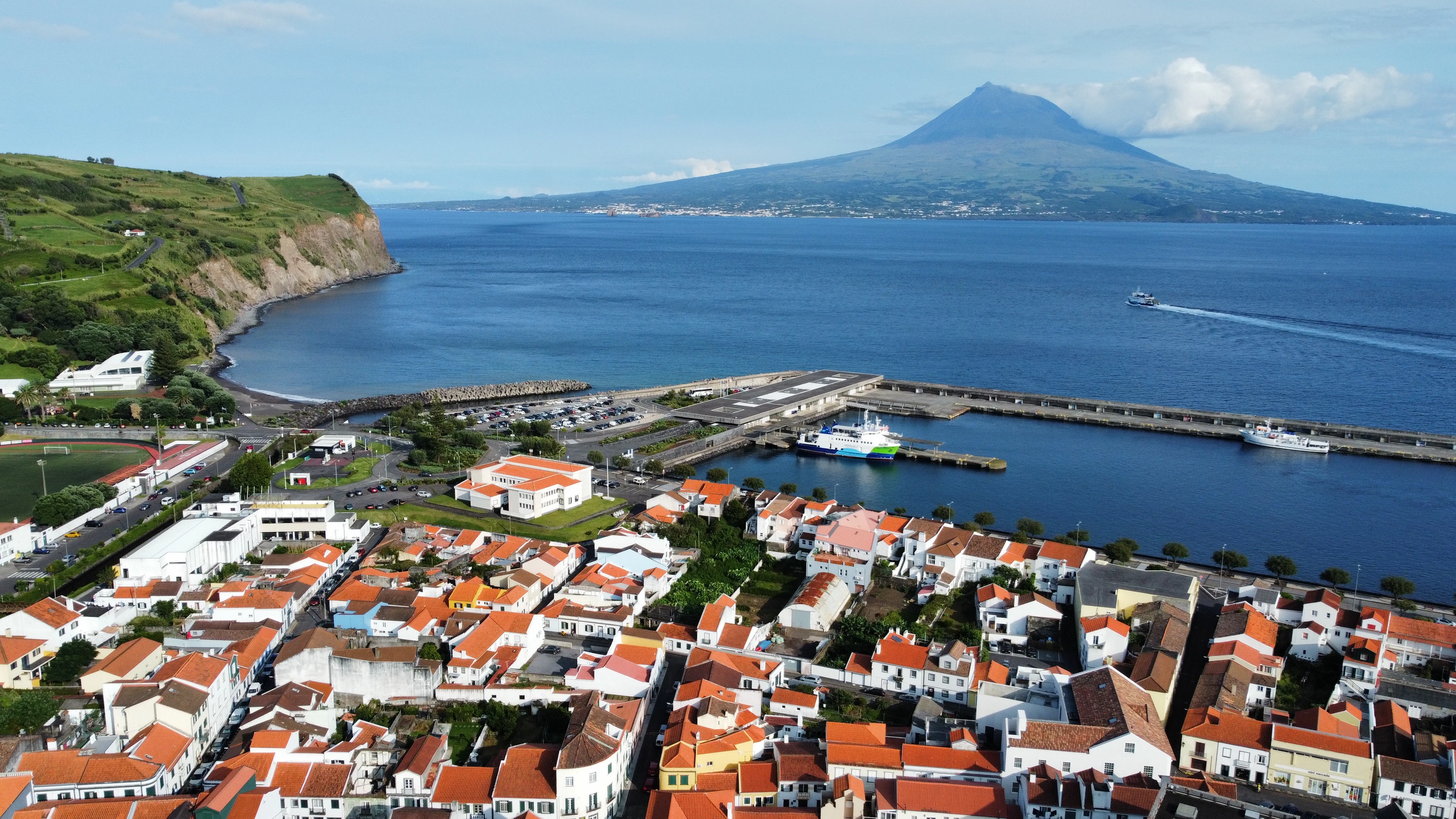 The rooftops and harbour of Horta on Faial, with the cone of Mount Pico across the channel