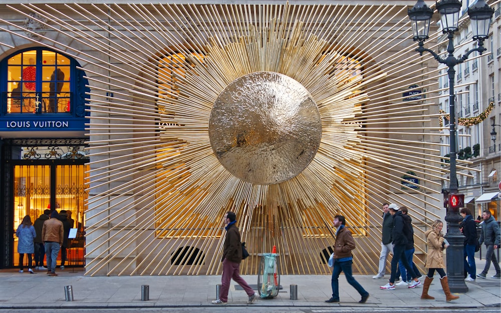 a group of people walking down a street next to a building