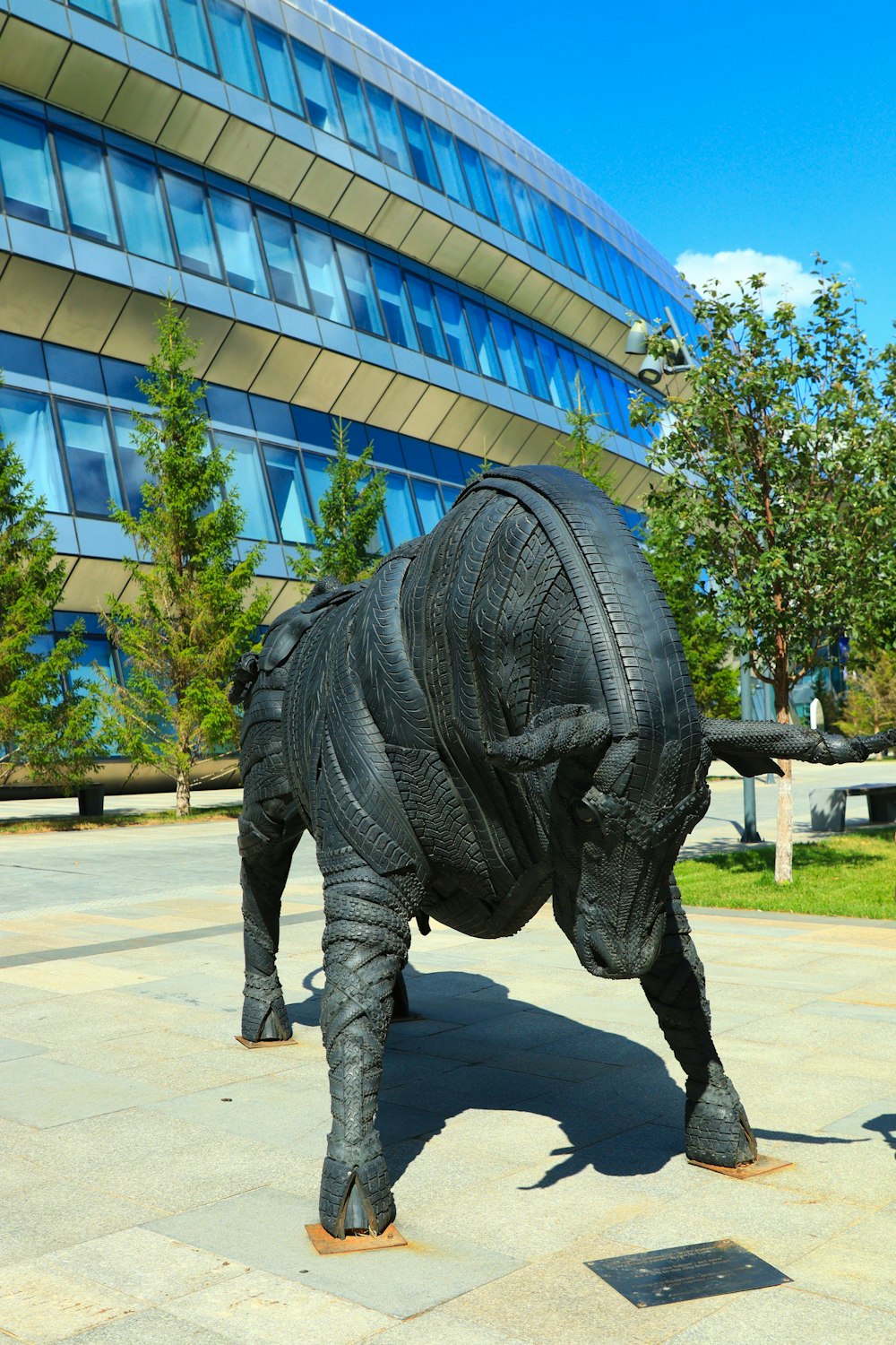 a sculpture of a rhino in front of a building