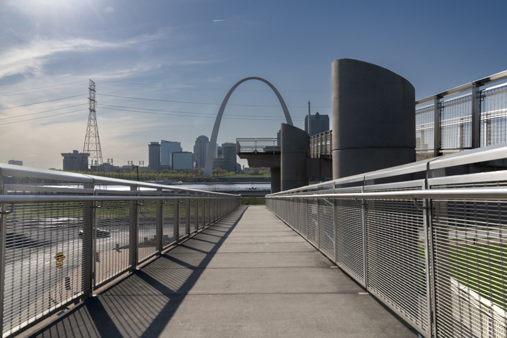 a bridge with a view of a city in the background