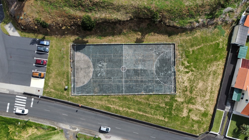 an aerial view of a basketball court in a parking lot