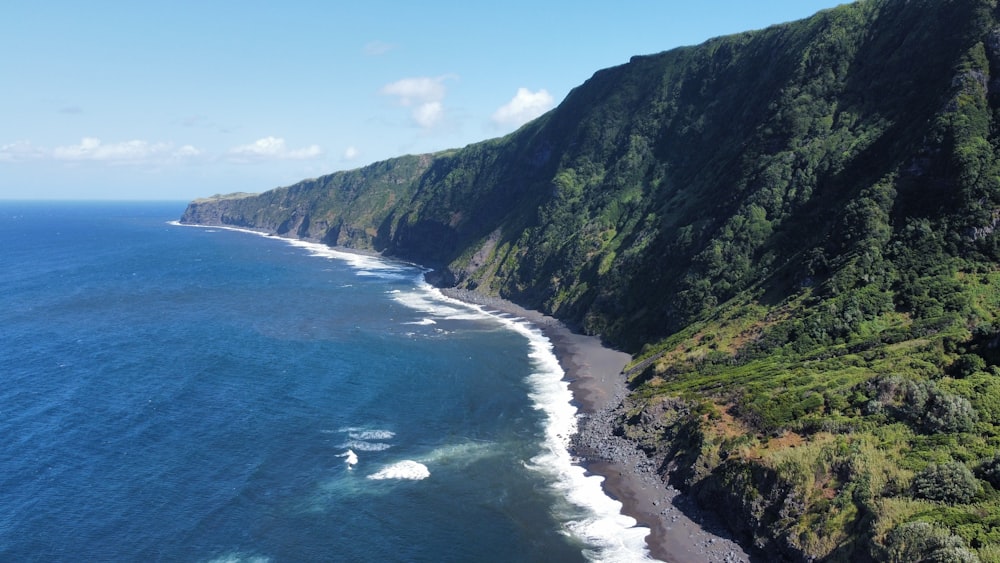 an aerial view of a beach near a cliff