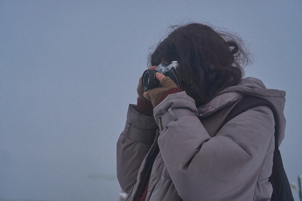 a woman taking a picture with her cell phone