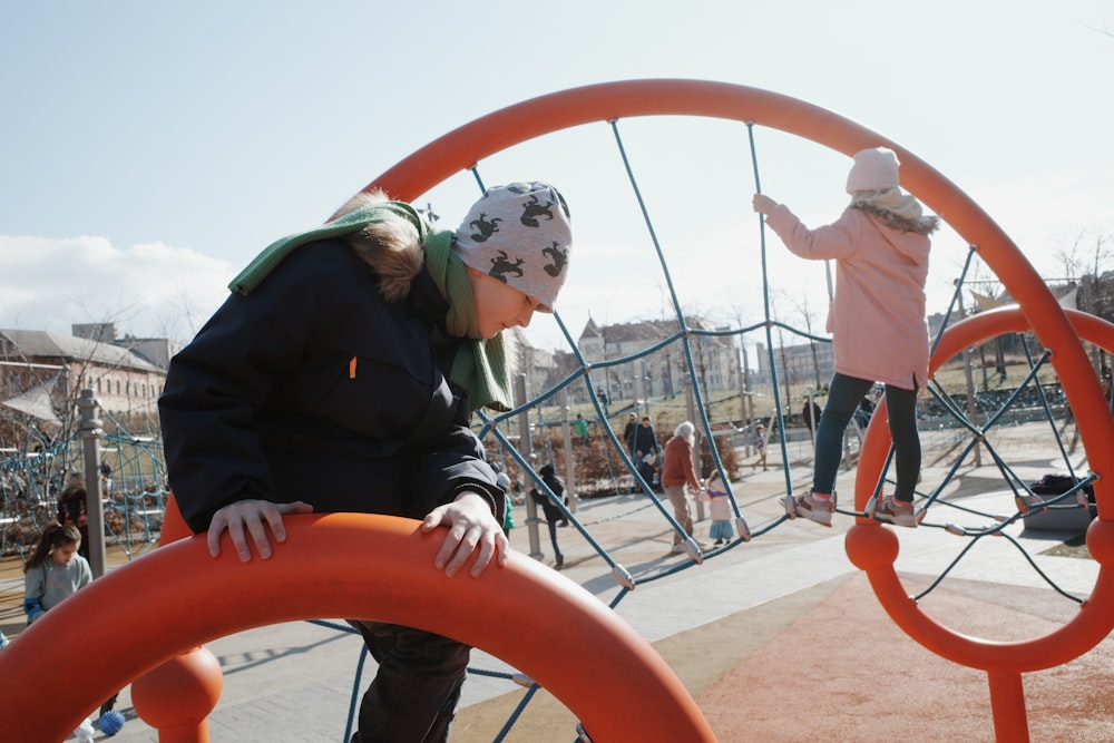 a little girl is playing on a playground