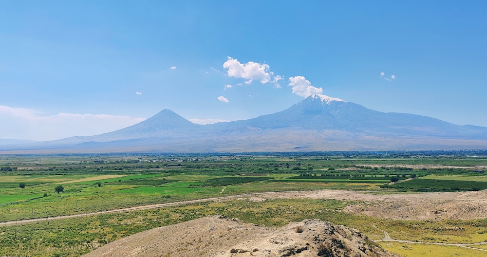 a scenic view of a mountain range with a blue sky