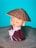 a small figurine of a boy with a straw hat