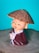 a small figurine of a boy with a straw hat