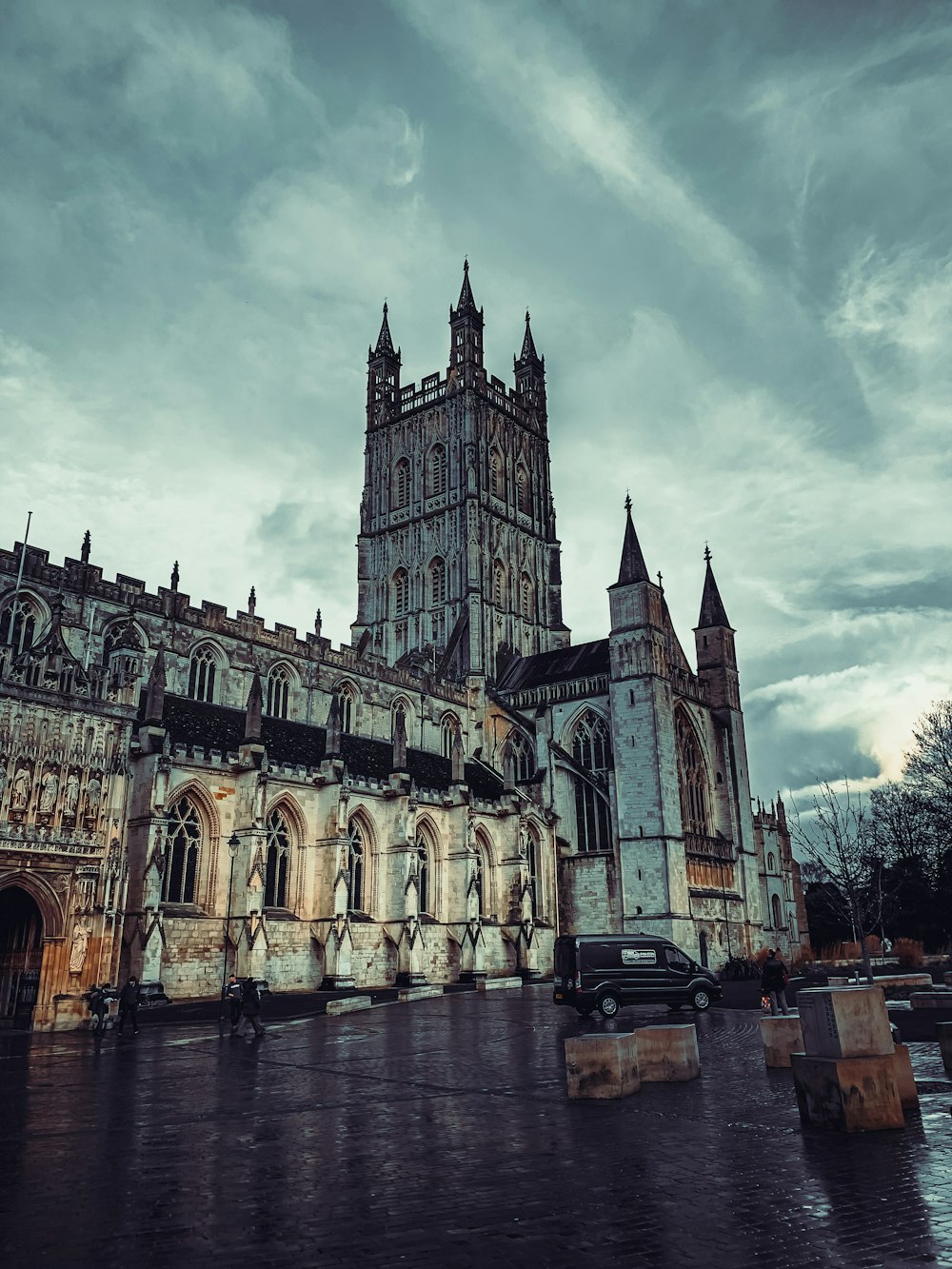 a large cathedral with a clock tower on a cloudy day