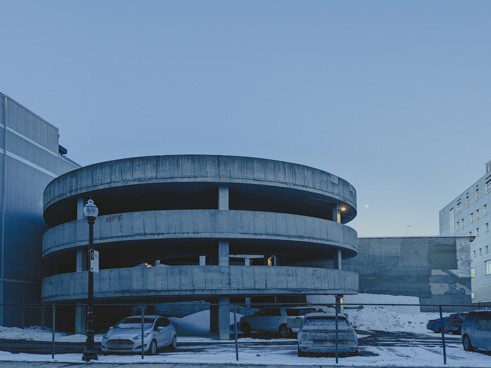 a round building with a parking lot in front of it