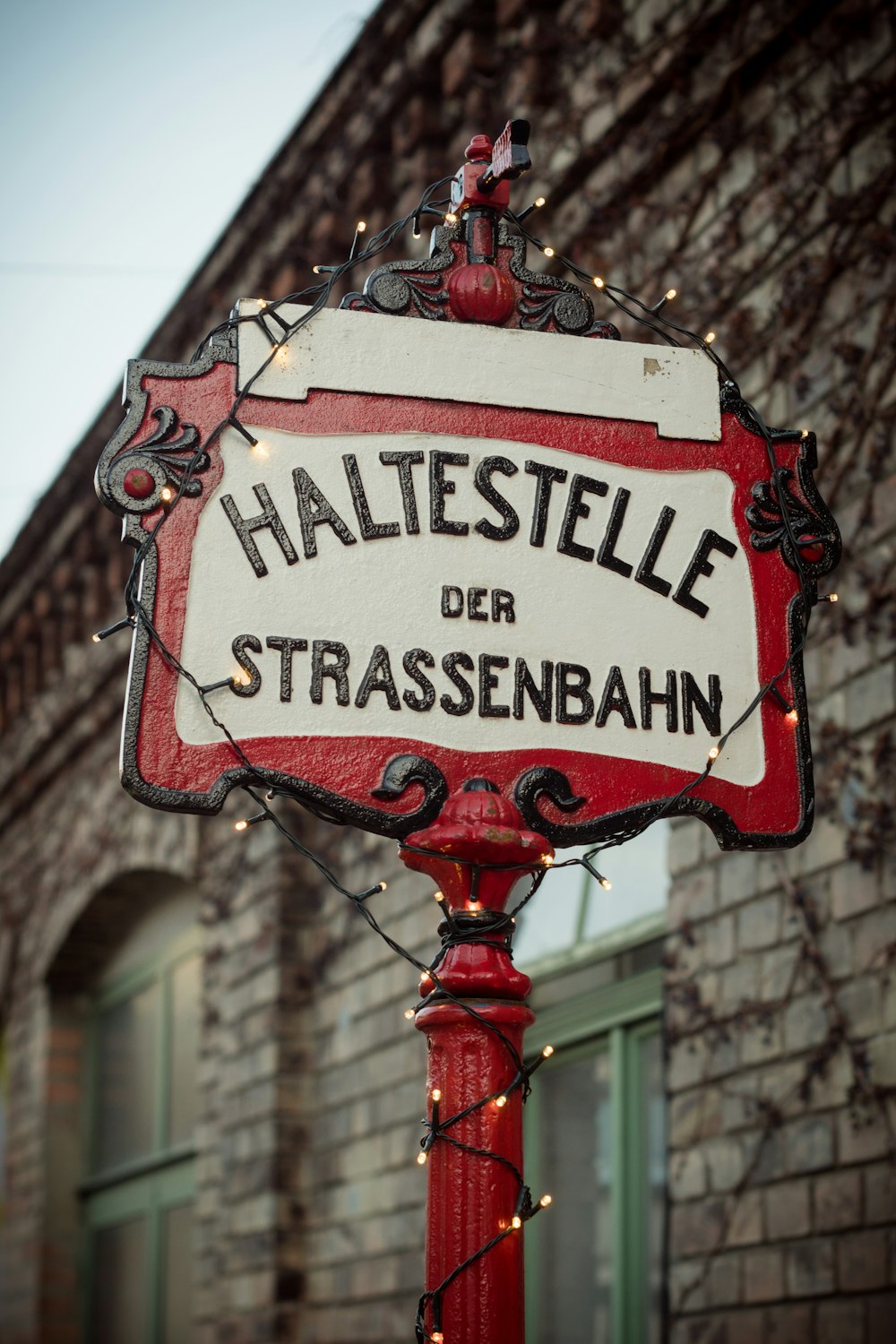 a red and white street sign sitting on top of a red pole