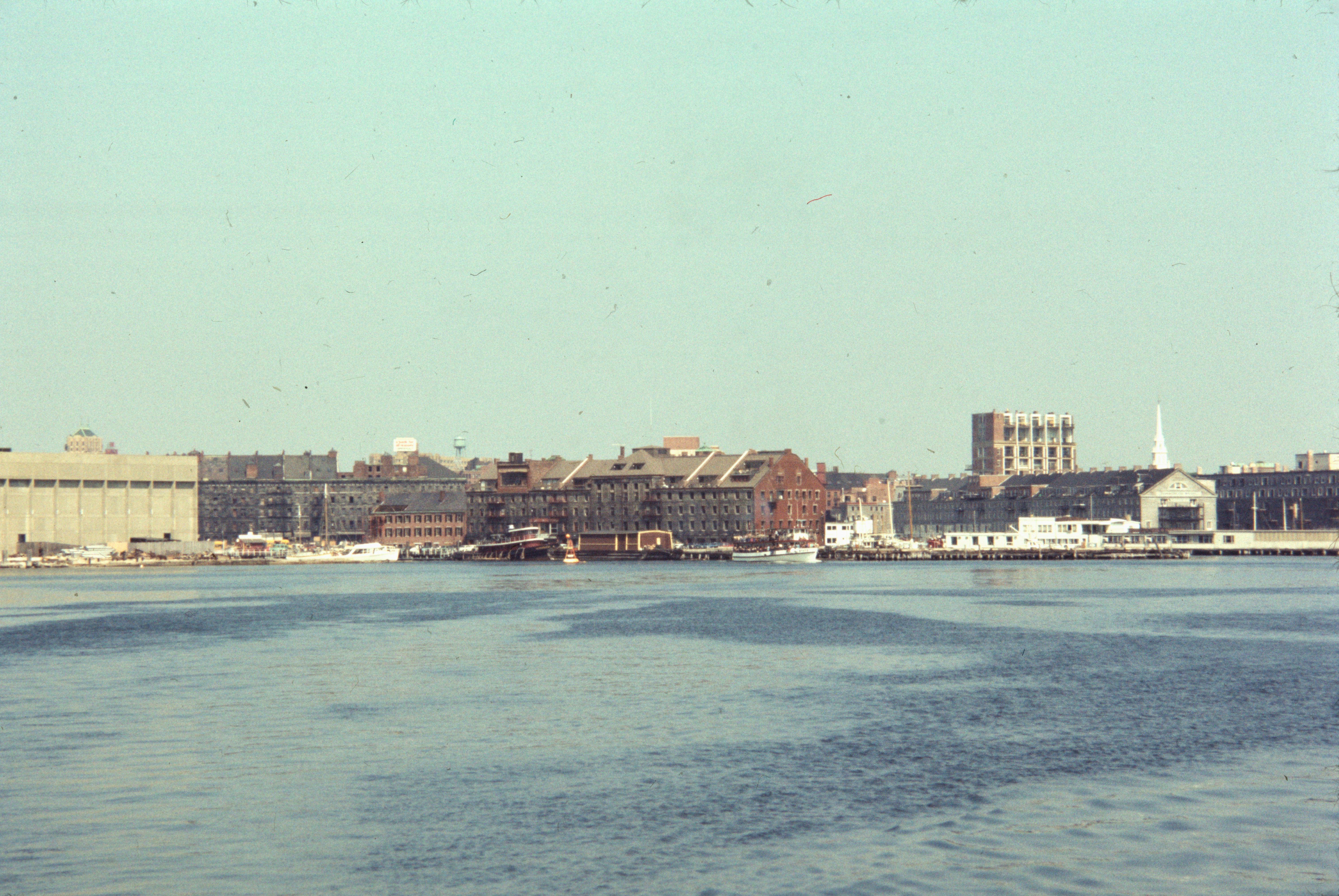 a body of water with a city in the background