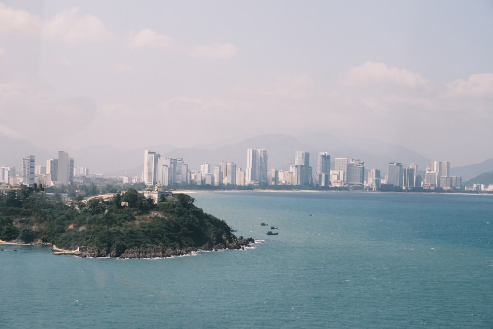 a large body of water with a city in the background