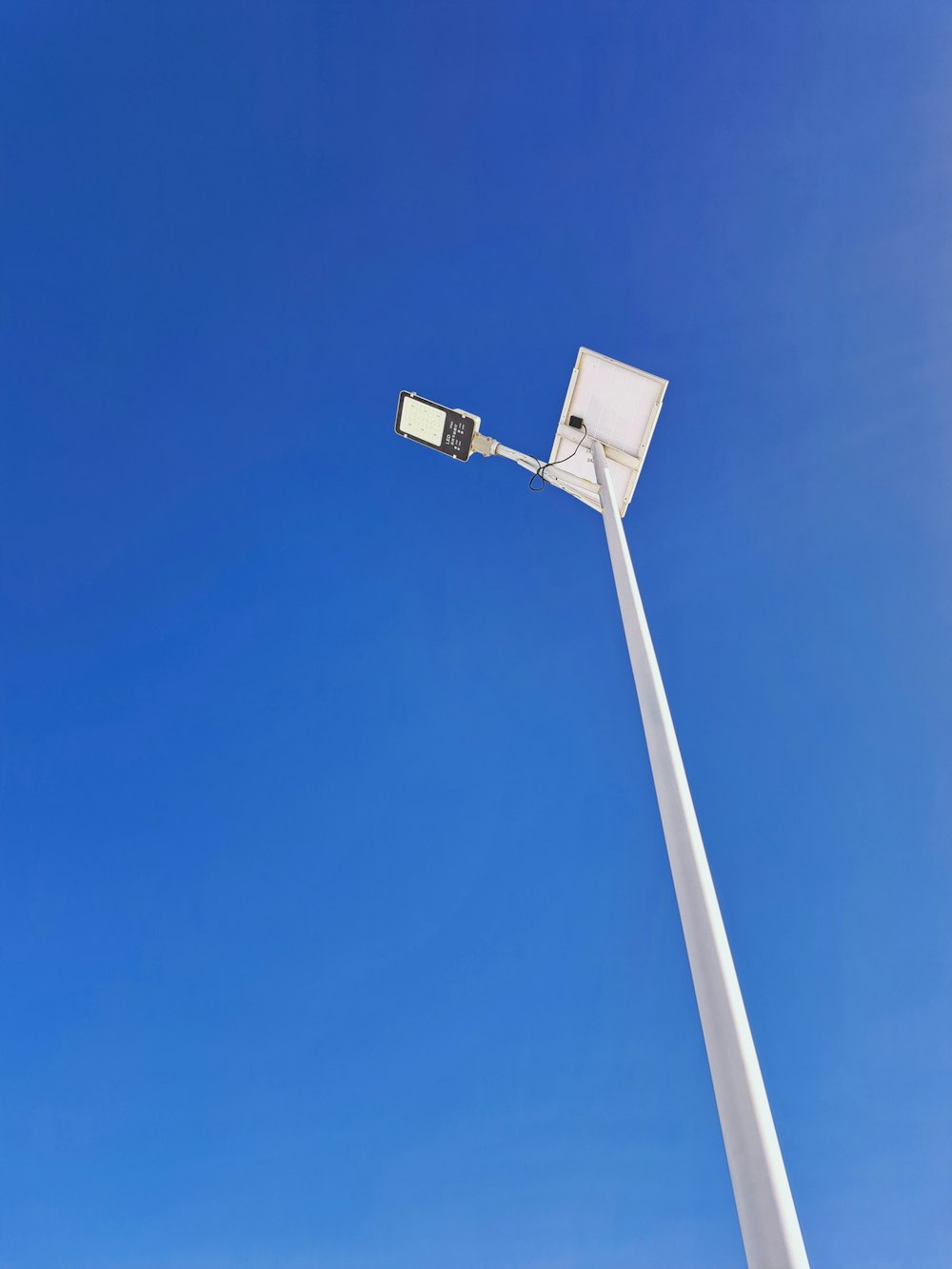 a street light with a blue sky in the background