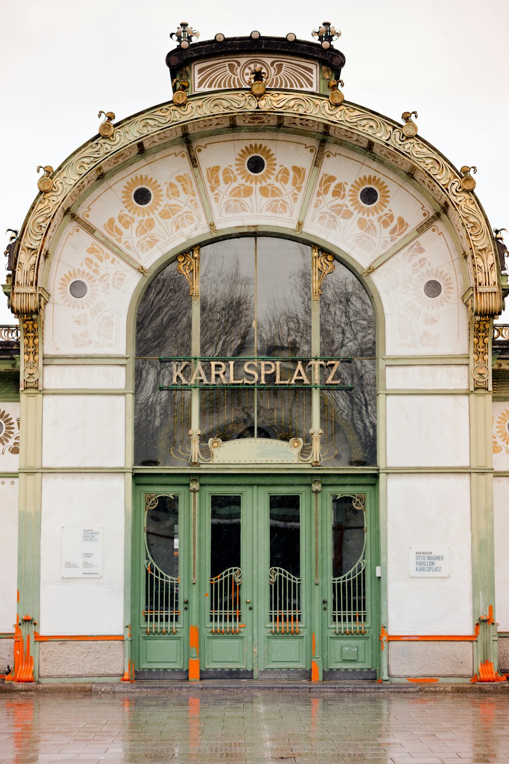 a large green and white building with a clock on it's side