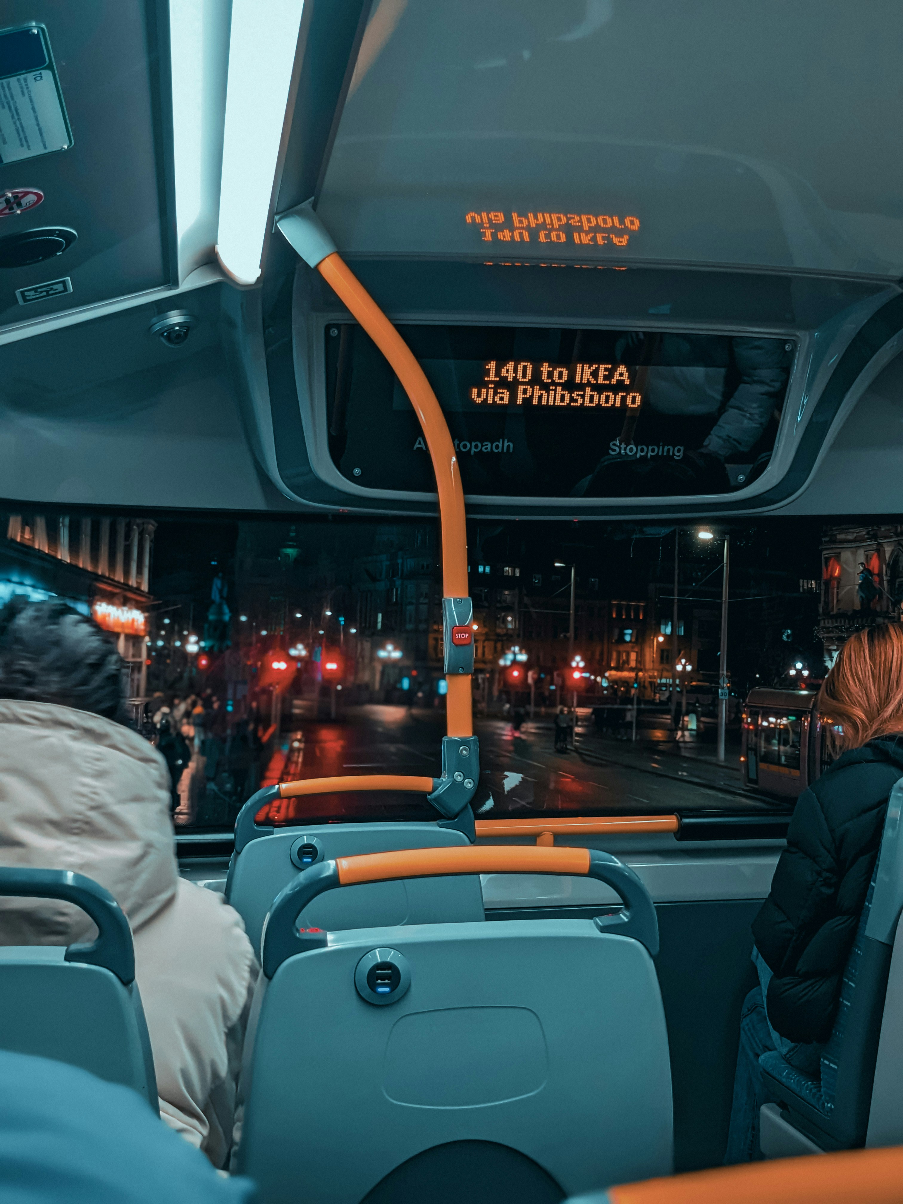 How to Navigate Public Transportation in a New City Like a Local – a group of people sitting on a bus at night