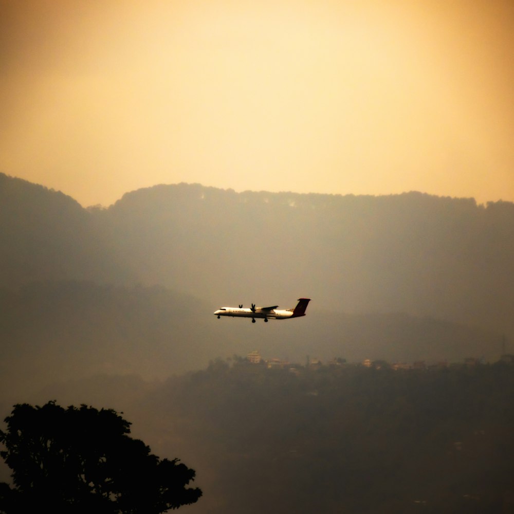 a plane is flying over a mountain range