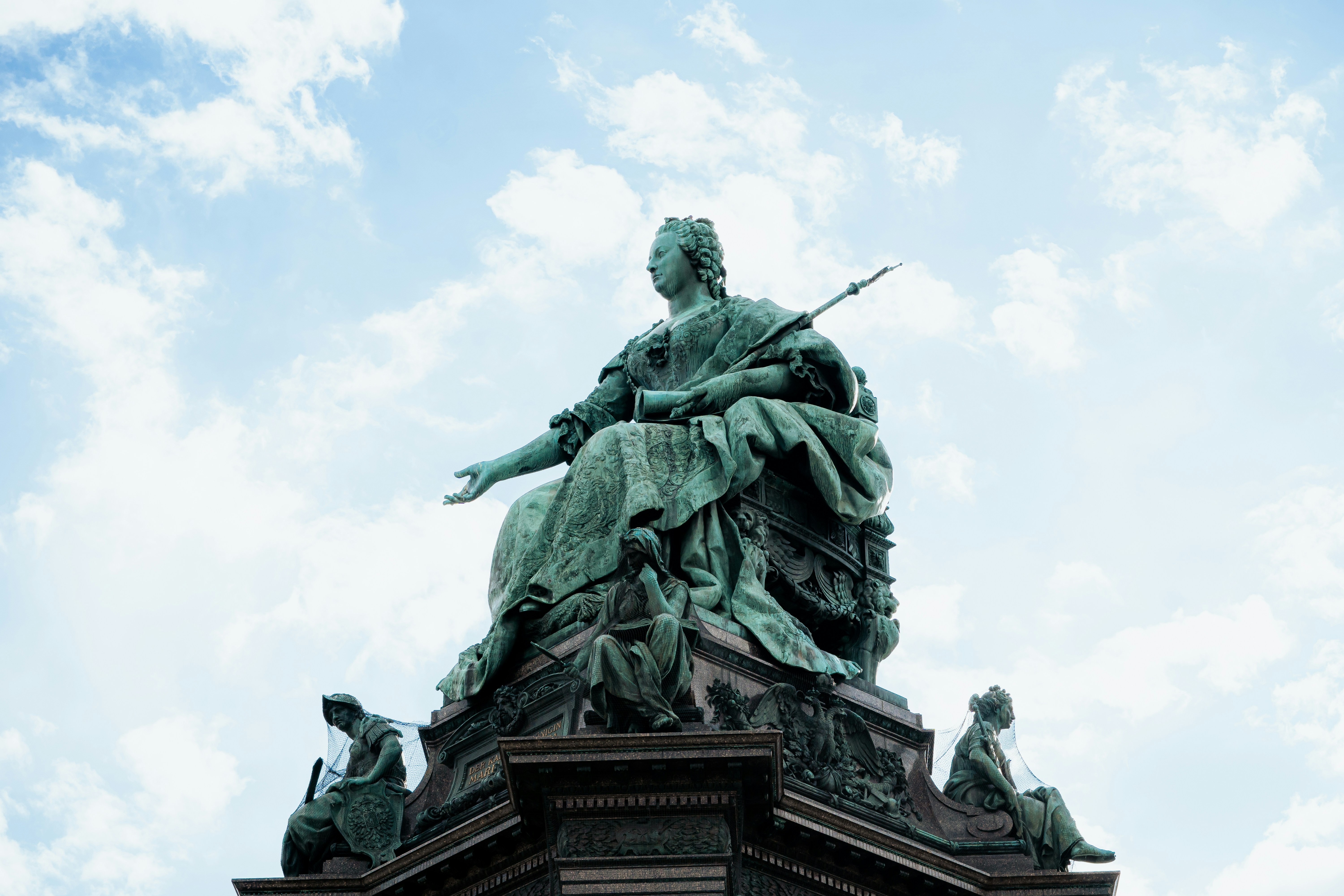 a statue on top of a building with a sky background