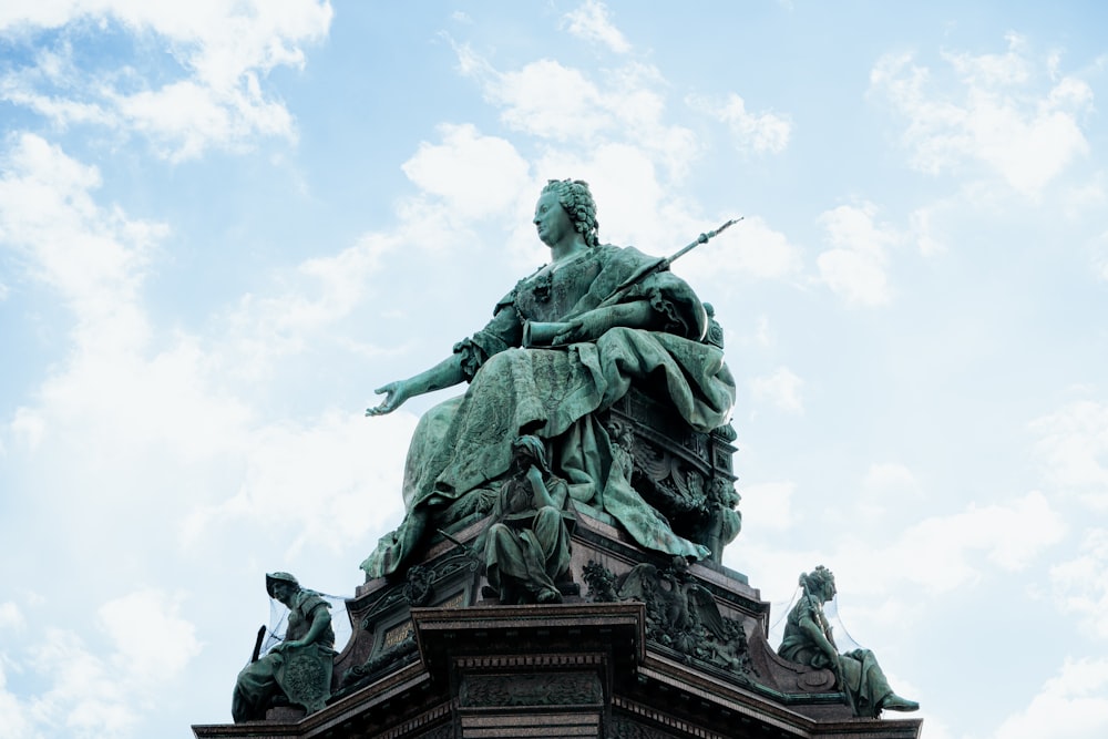 a statue on top of a building with a sky background