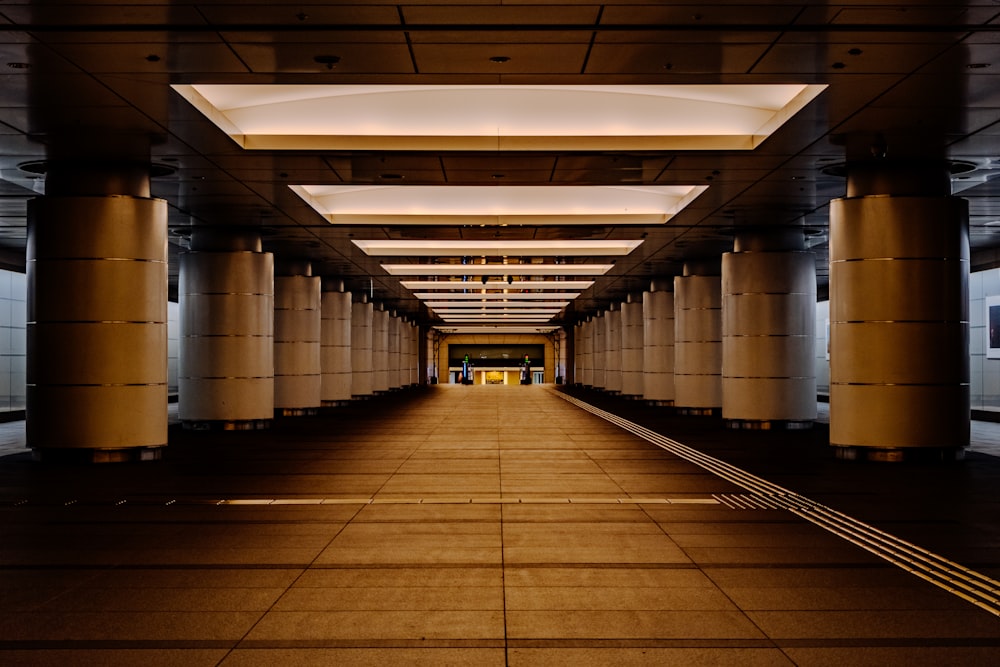 a very long hallway with some lights on the ceiling