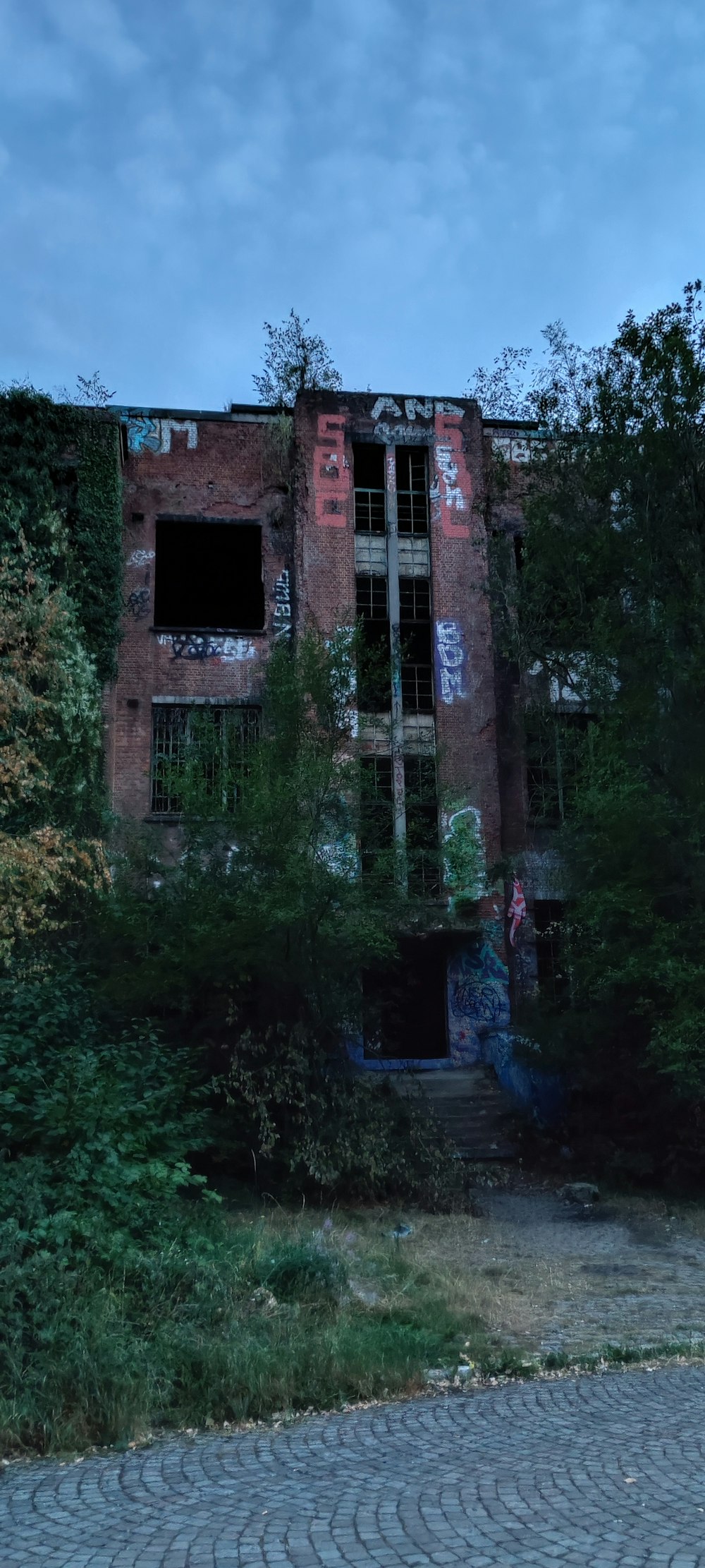 a person standing in front of an abandoned building